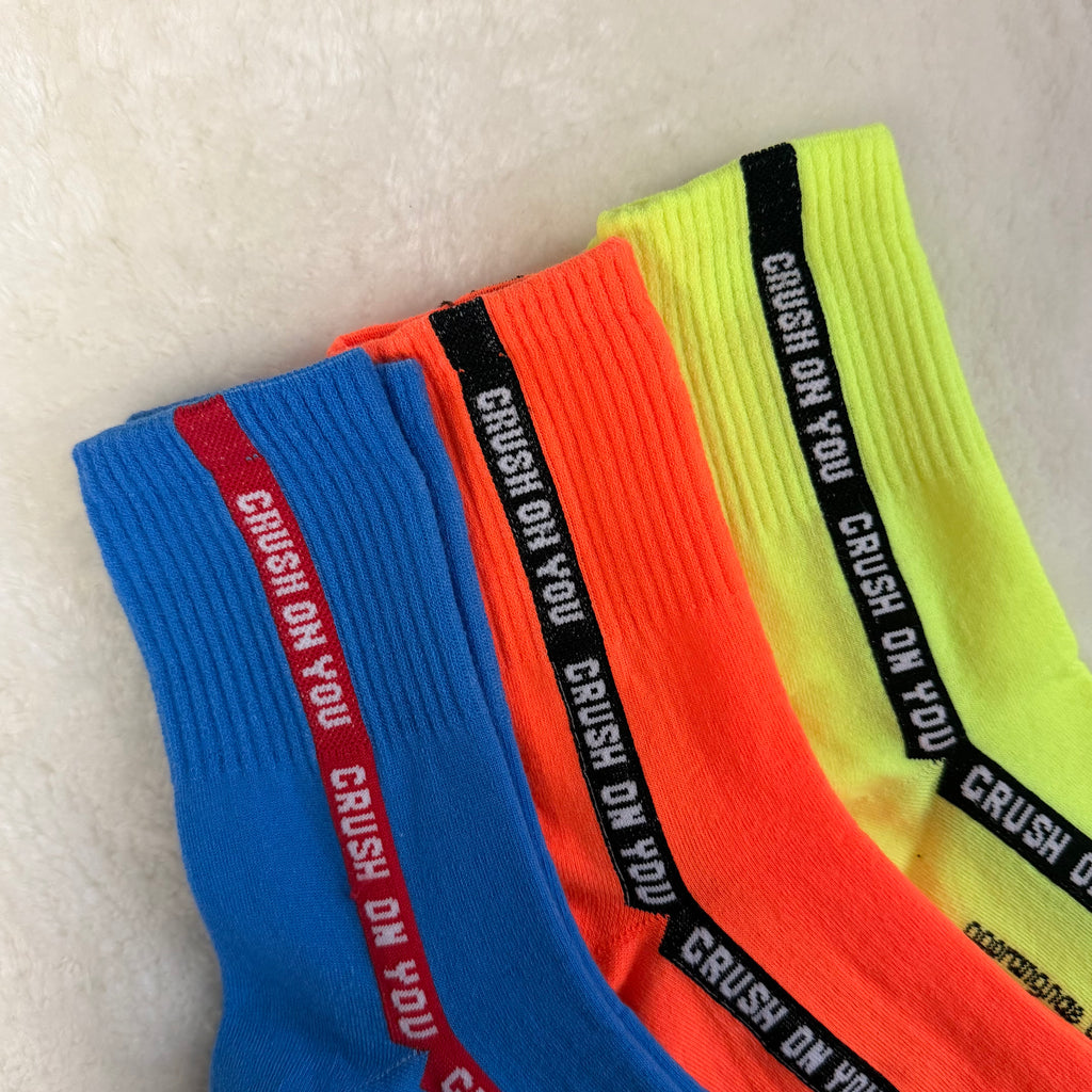 Three colorful socks with 'CRUSH ON YOU' text on a light background