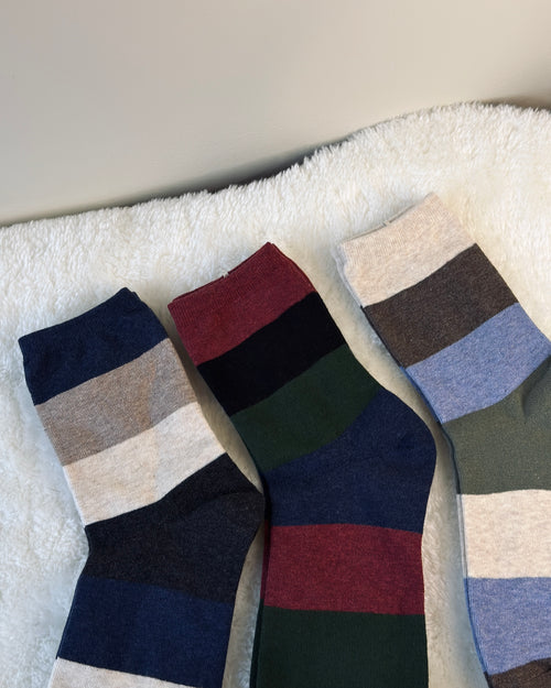 Three pairs of classic striped crew socks in navy, burgundy, and forest green earth-tone patterns.