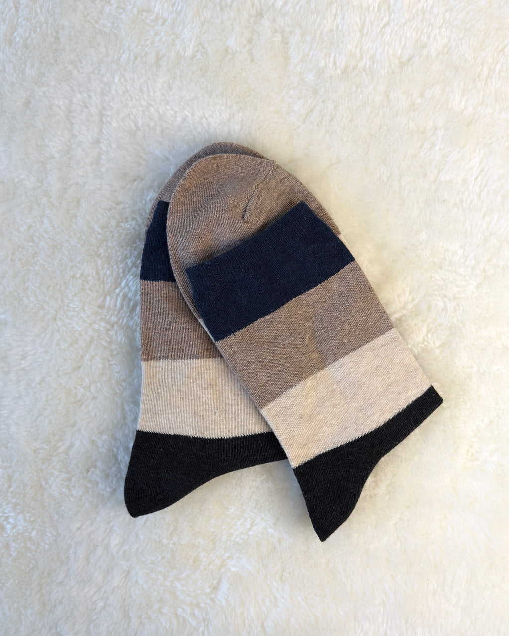 Striped sock with Nave, Grey, and Cream colors on a white background